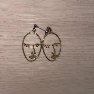Gold face earrings